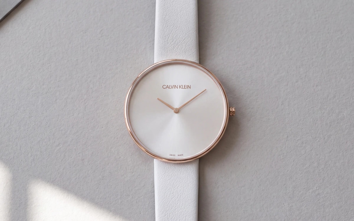 Calvin Klein Full Moon K8Y236L6 rose gold women's watch with a large plain dial, white leather strap on pearl-grey paper