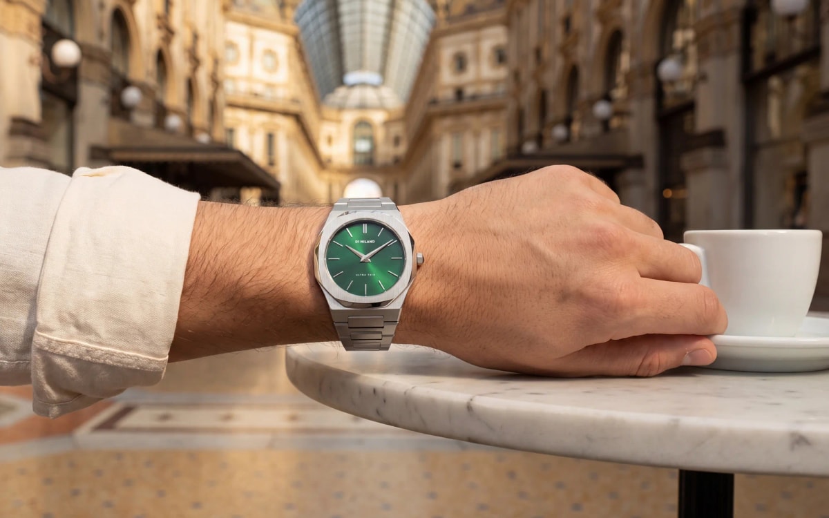 Green dial D1 Milano Ultra Thin worn at a café table in Milan's Galleria