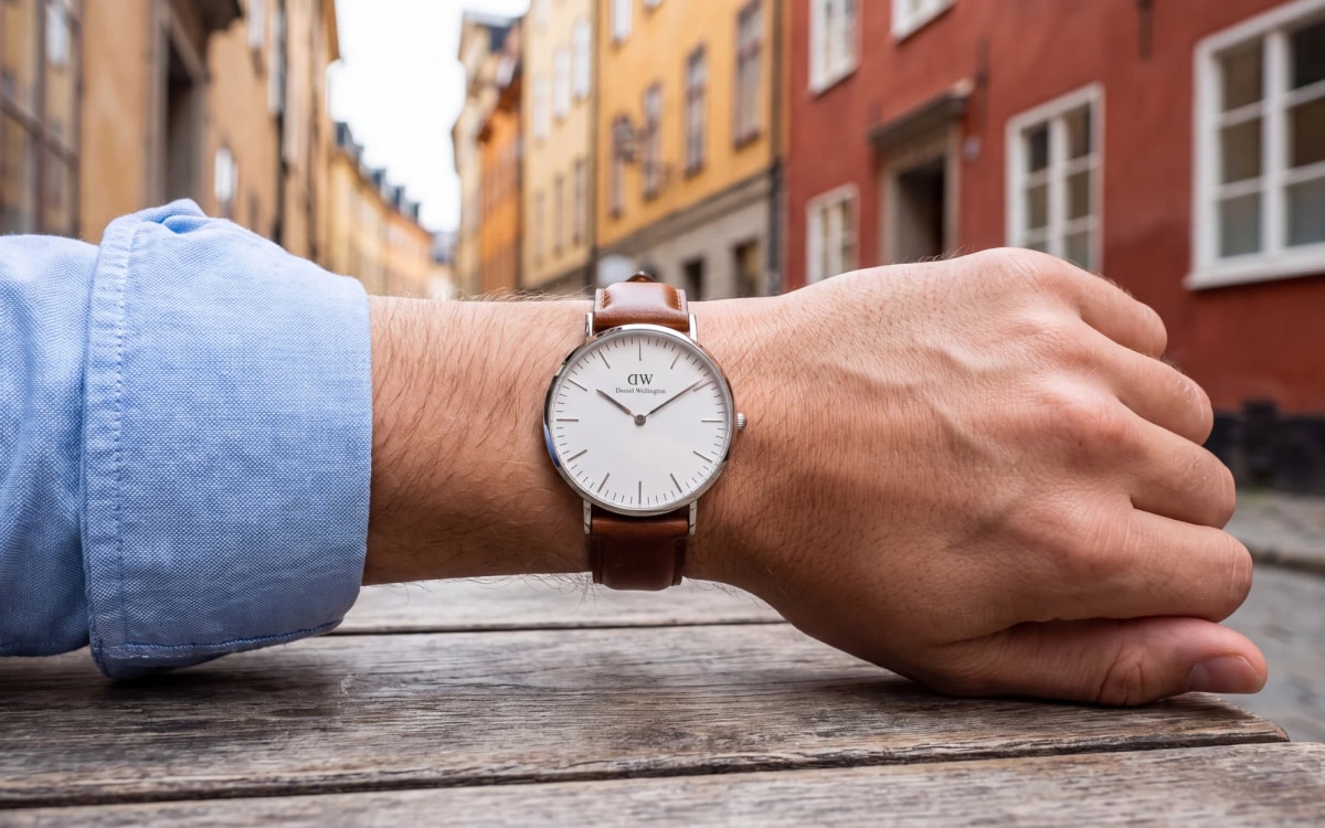 Daniel Wellington Classic 40 mm steel watch on a leather strap worn in a Gamla Stan street