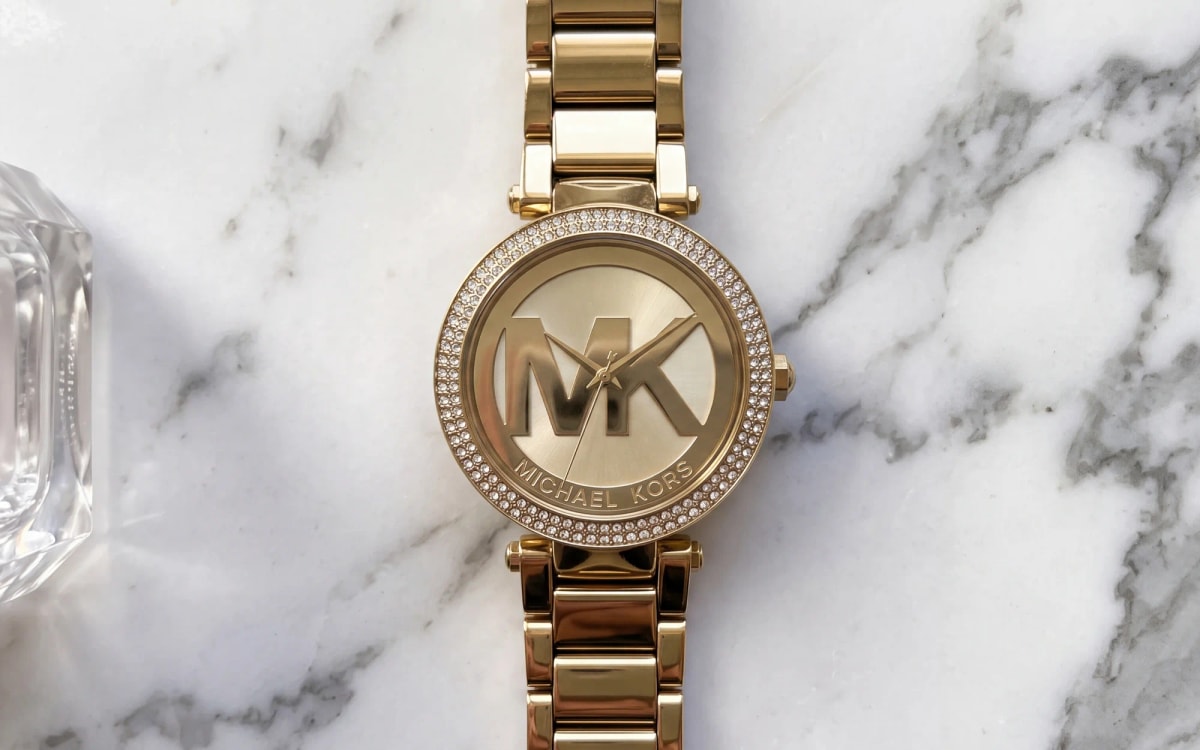 Michael Kors Parker MK5784 gold-tone watch with crystal bezel and MK logo dial on Calacatta marble