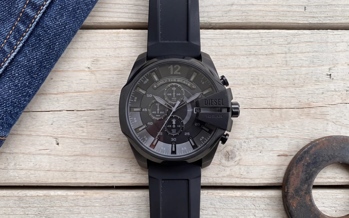 Diesel Mega Chief DZ4378 all-black chronograph with silicone strap on pallet wood beside raw denim