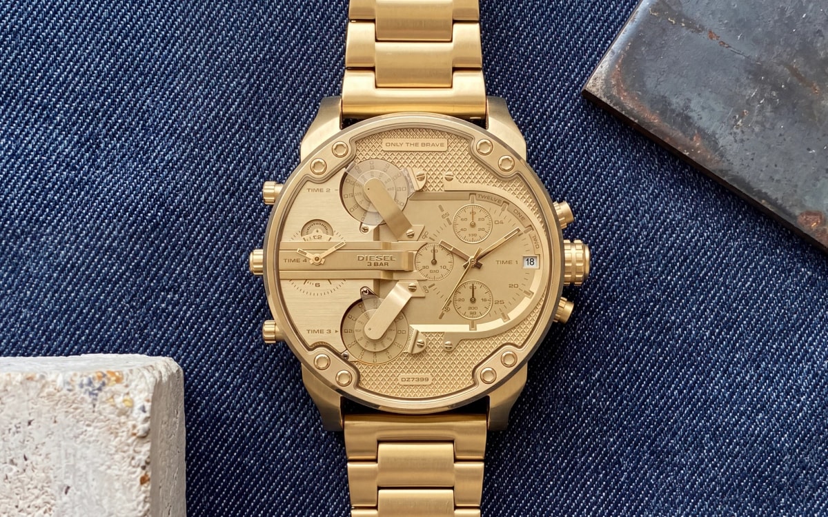 Diesel Mr Daddy DZ7399 all gold-tone watch with textured gold dial on raw indigo denim